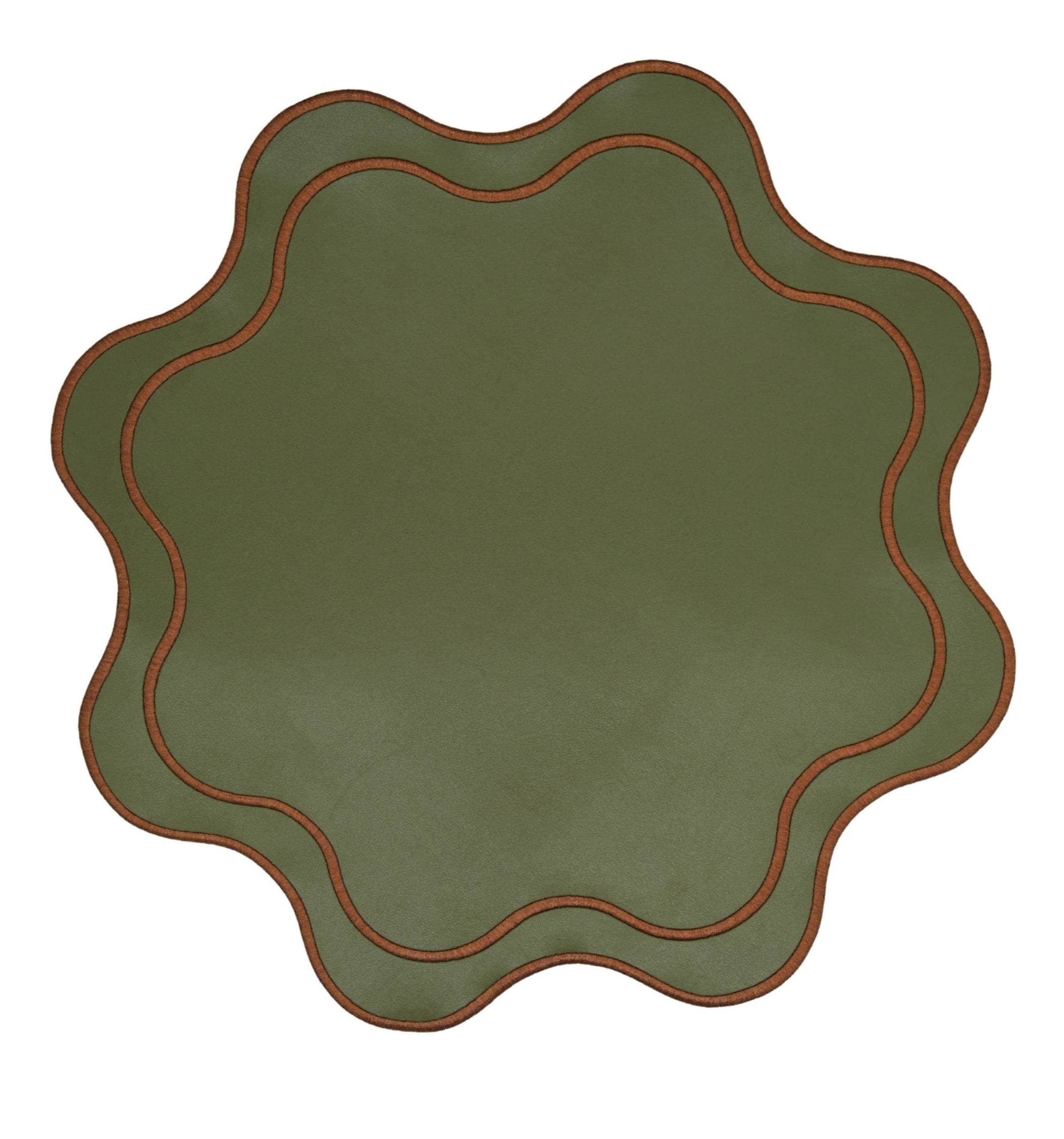 Round green placemat with brown scalloped edge on a white background