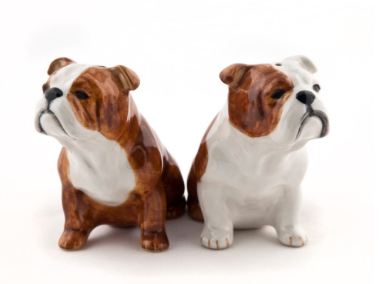 Two ceramic bulldog figurines on a white background