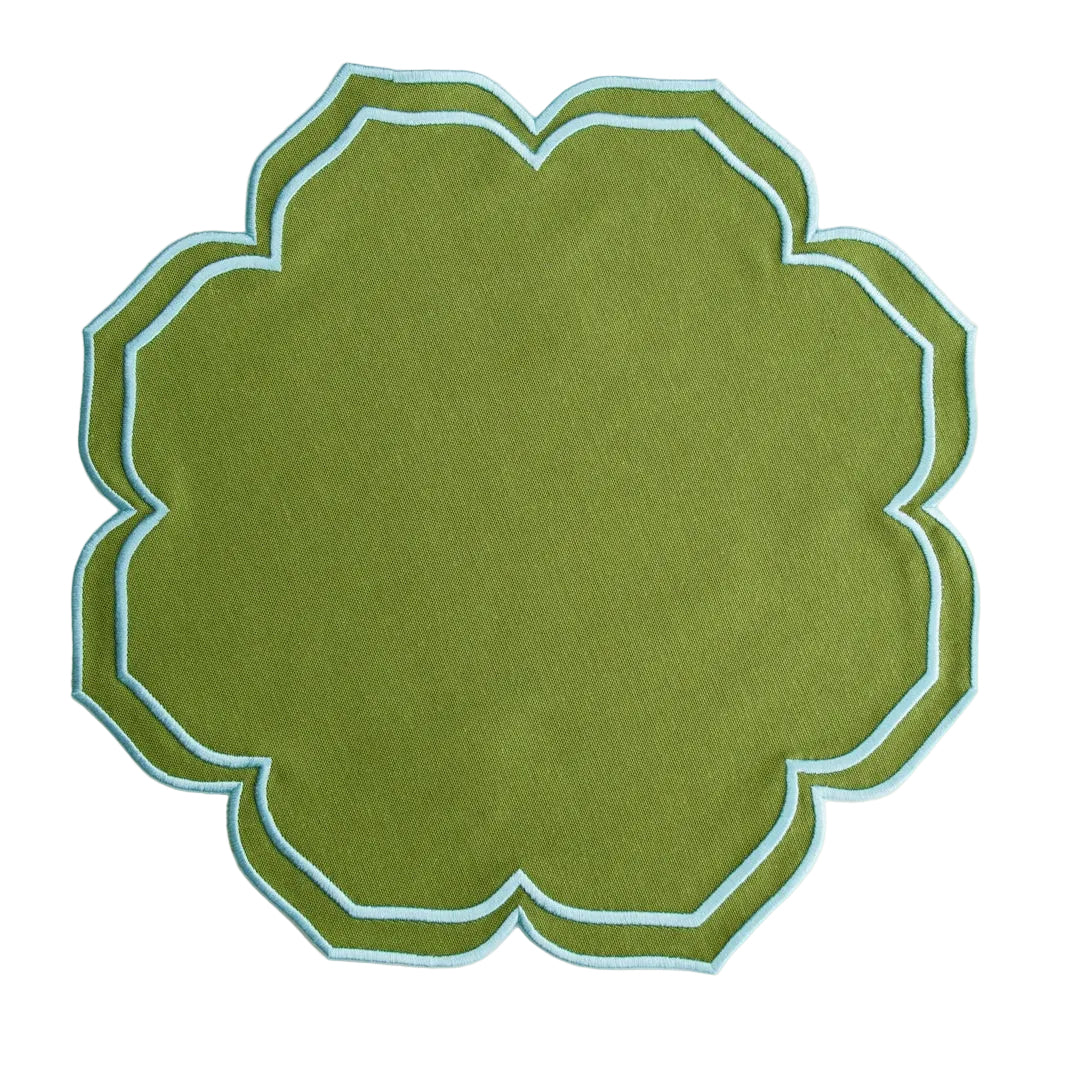 Green fabric patch with scalloped edge on a white background