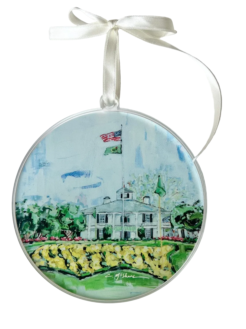 Decorative ornament with a painting of a house and garden, tied with a ribbon on a white background.