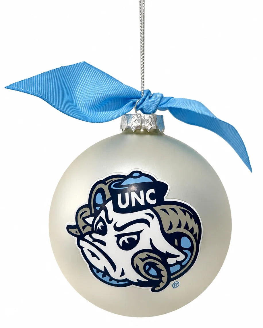 A glossy white Christmas ornament featuring the UNC Blue Devils mascot logo, decorated with a light blue satin ribbon bow at the top, shown against a plain white background.