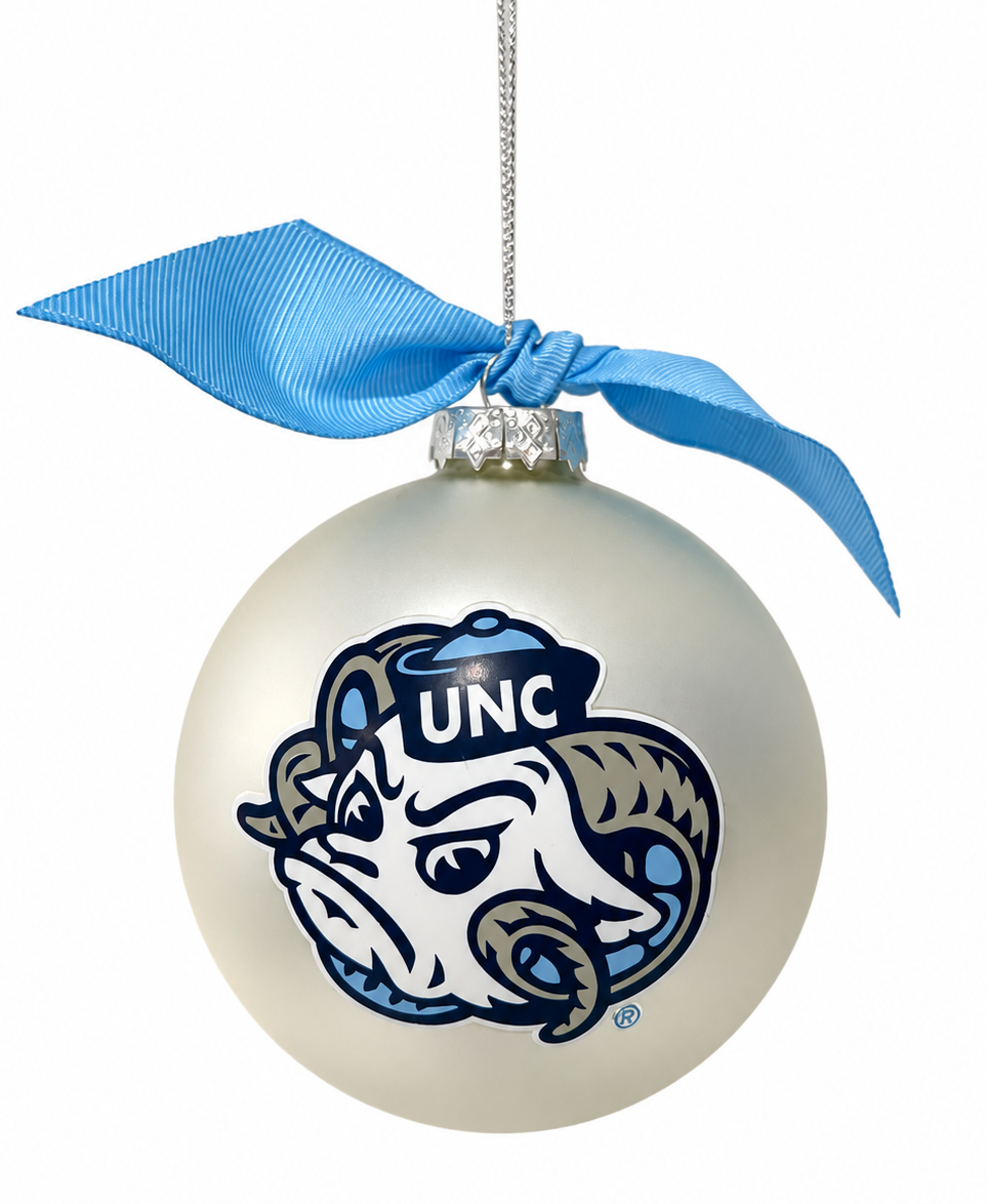 A glossy white Christmas ornament featuring the UNC Blue Devils mascot logo, decorated with a light blue satin ribbon bow at the top, shown against a plain white background.