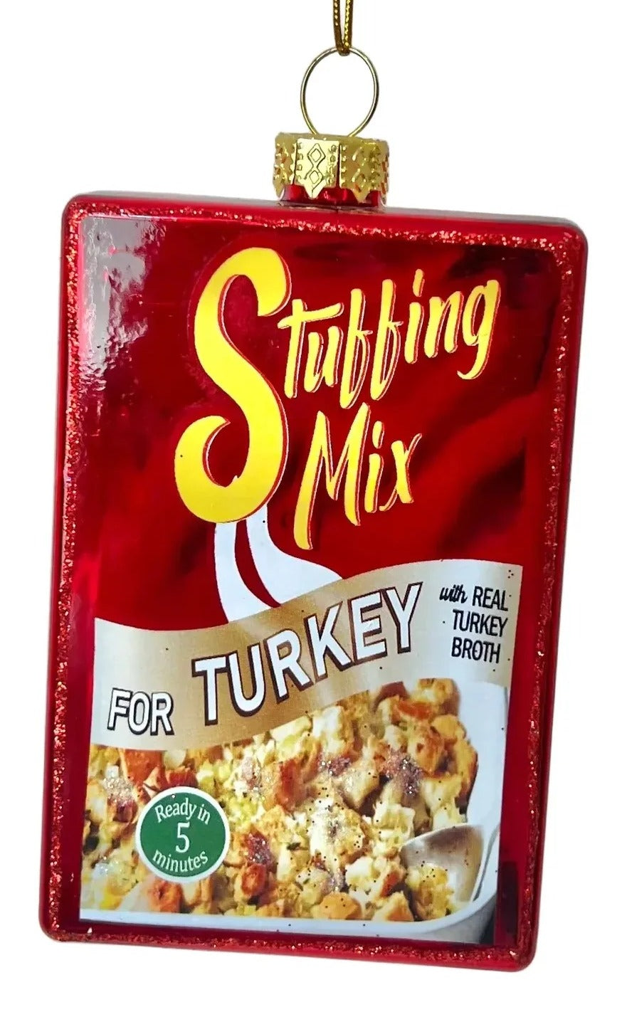 Decorative ornament shaped like a box of stuffing mix on a plain background