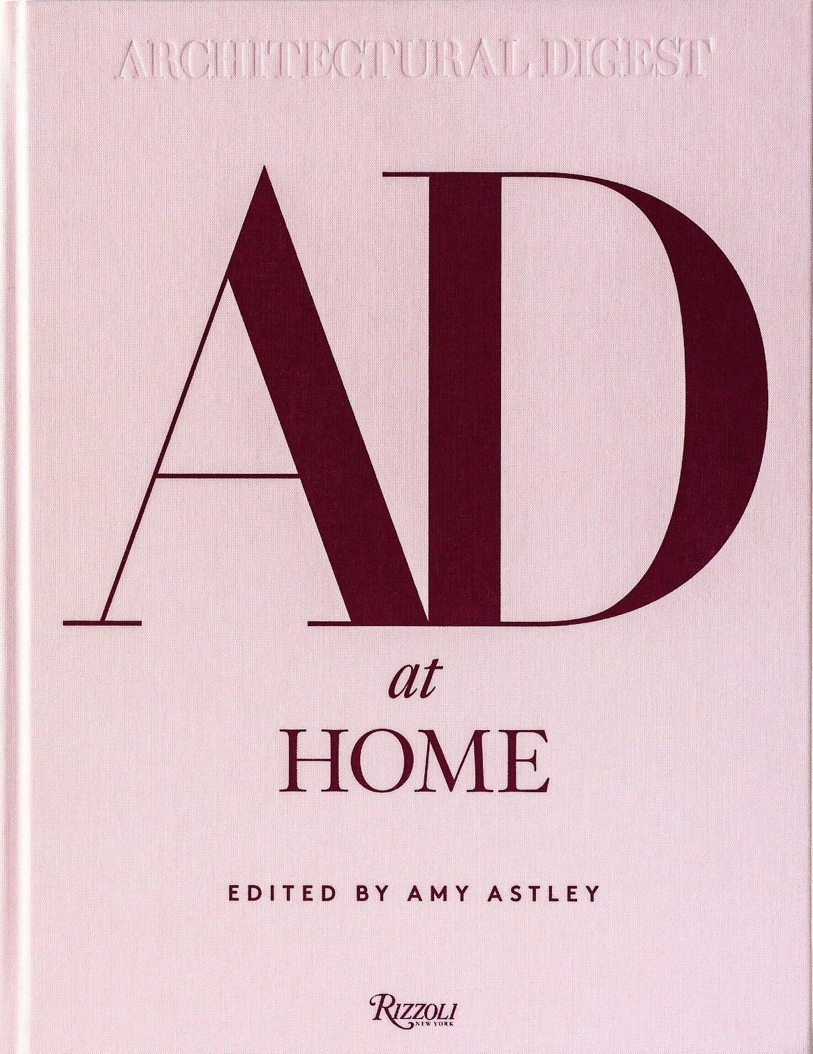 Book titled 'AD at Home' edited by Amy Astley on a pink background