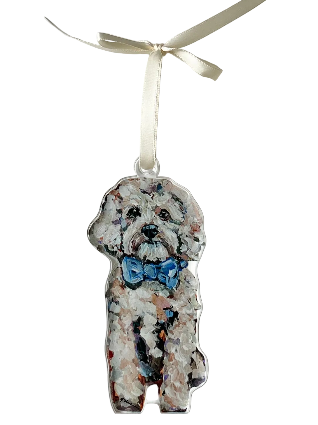 Dog-shaped ornament with a blue bow tie on a white background