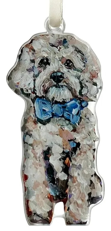 Dog-shaped ornament with a blue bow tie on a white background
