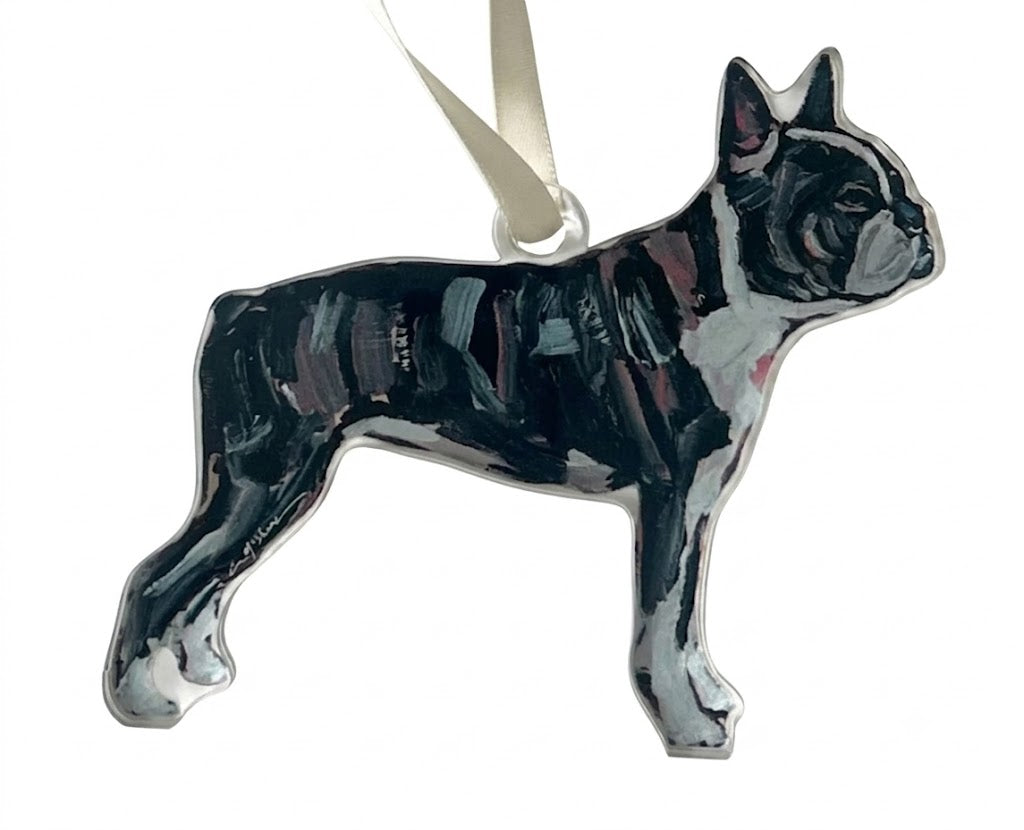 A glossy black and white dog-shaped ornament, shaped like a French Bulldog, with a white hanging ribbon, shown against a plain white background.