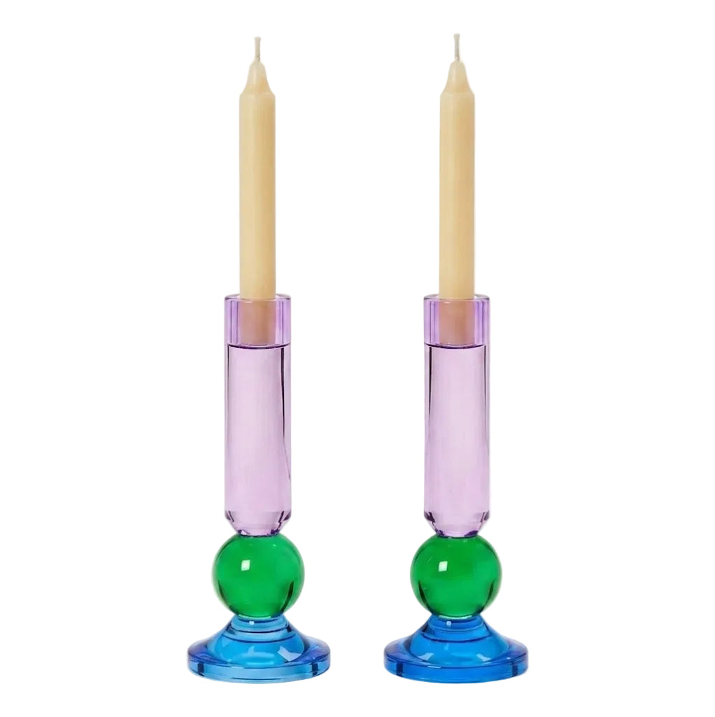 Two colorful candle holders with candles on a white background