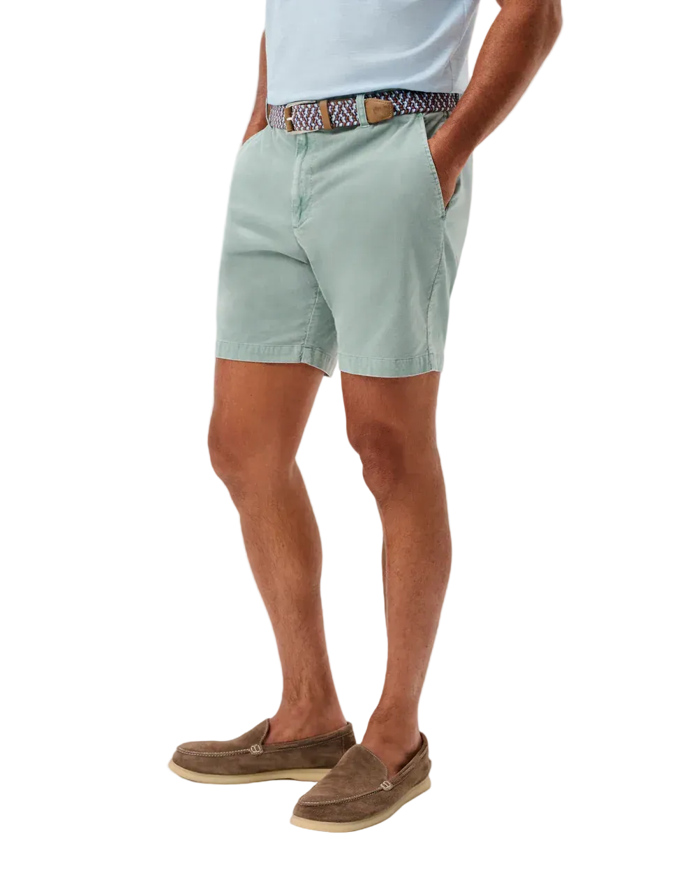 Person wearing light green shorts and brown shoes on a white background