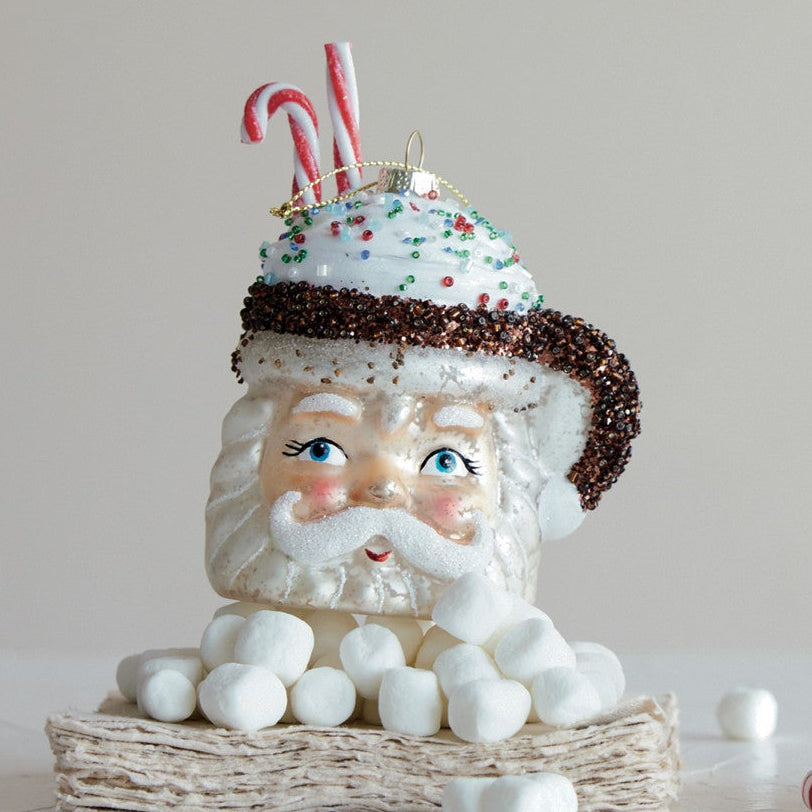 Two Christmas-themed glass ornaments on a light background
