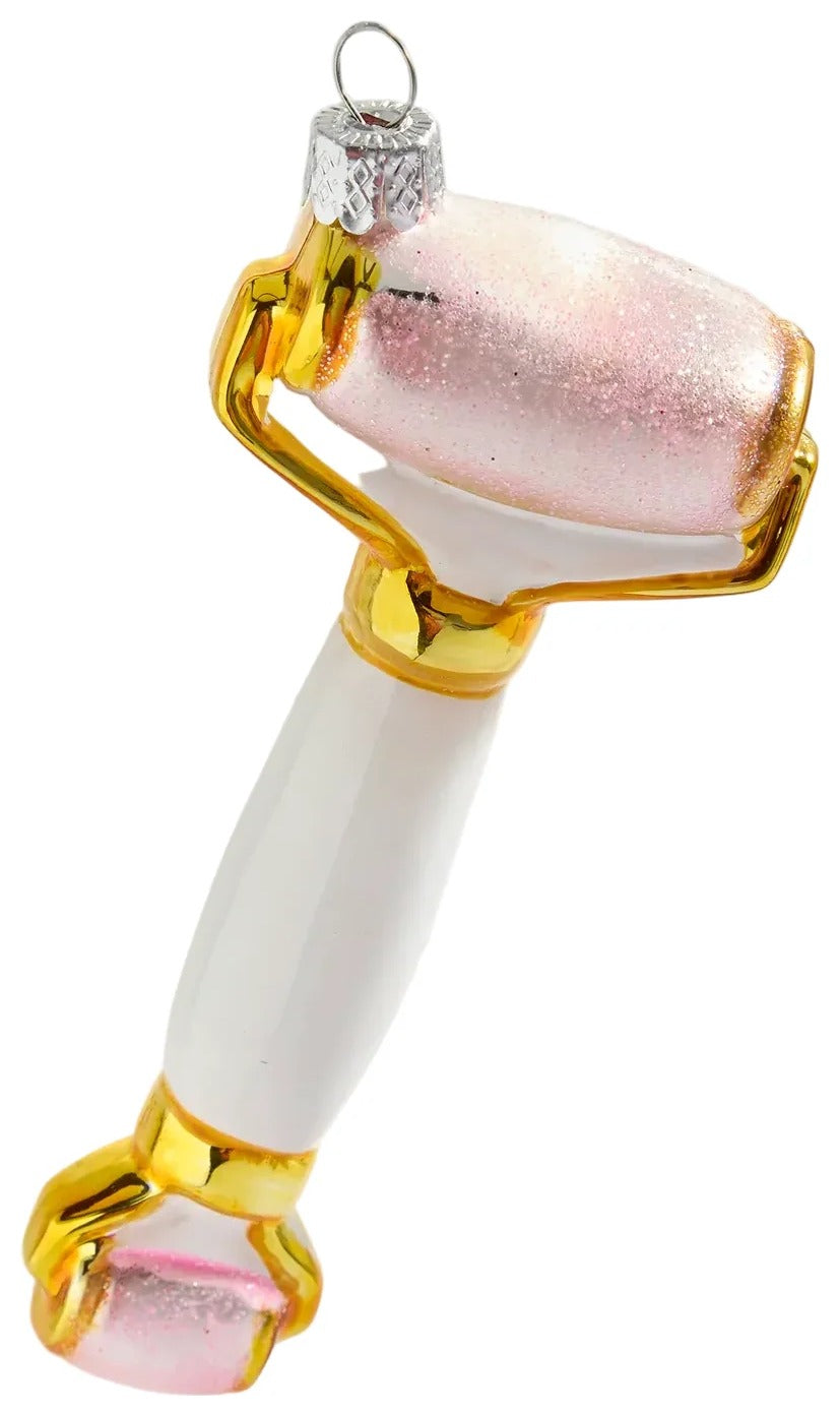 Decorative glass roller with gold and white design on a white background