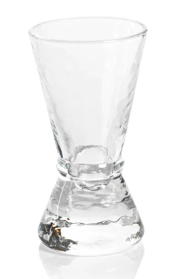 Clear glass shot glass on a white background