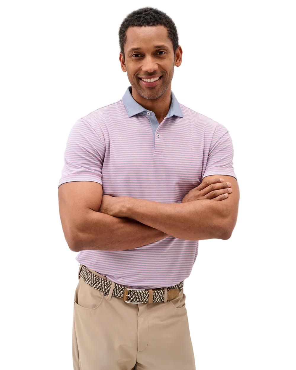 Man wearing a striped polo shirt and beige pants against a plain background