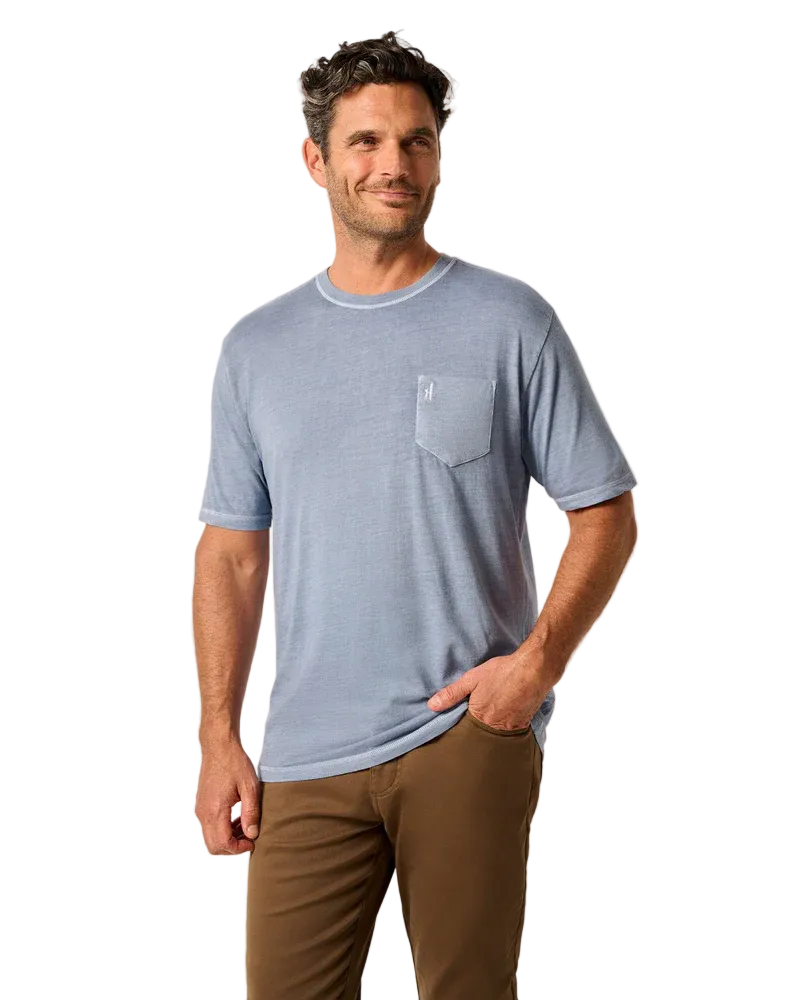 Man wearing a blue striped t-shirt with a pocket on a beige background