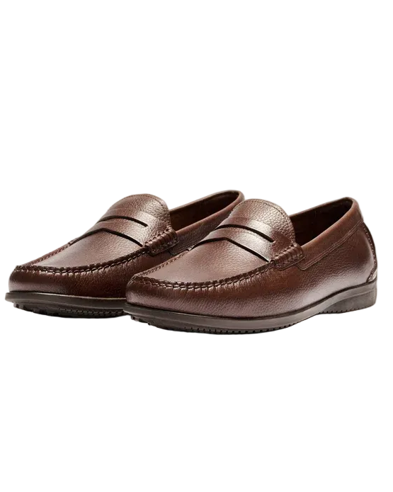 Pair of brown loafers on a beige background