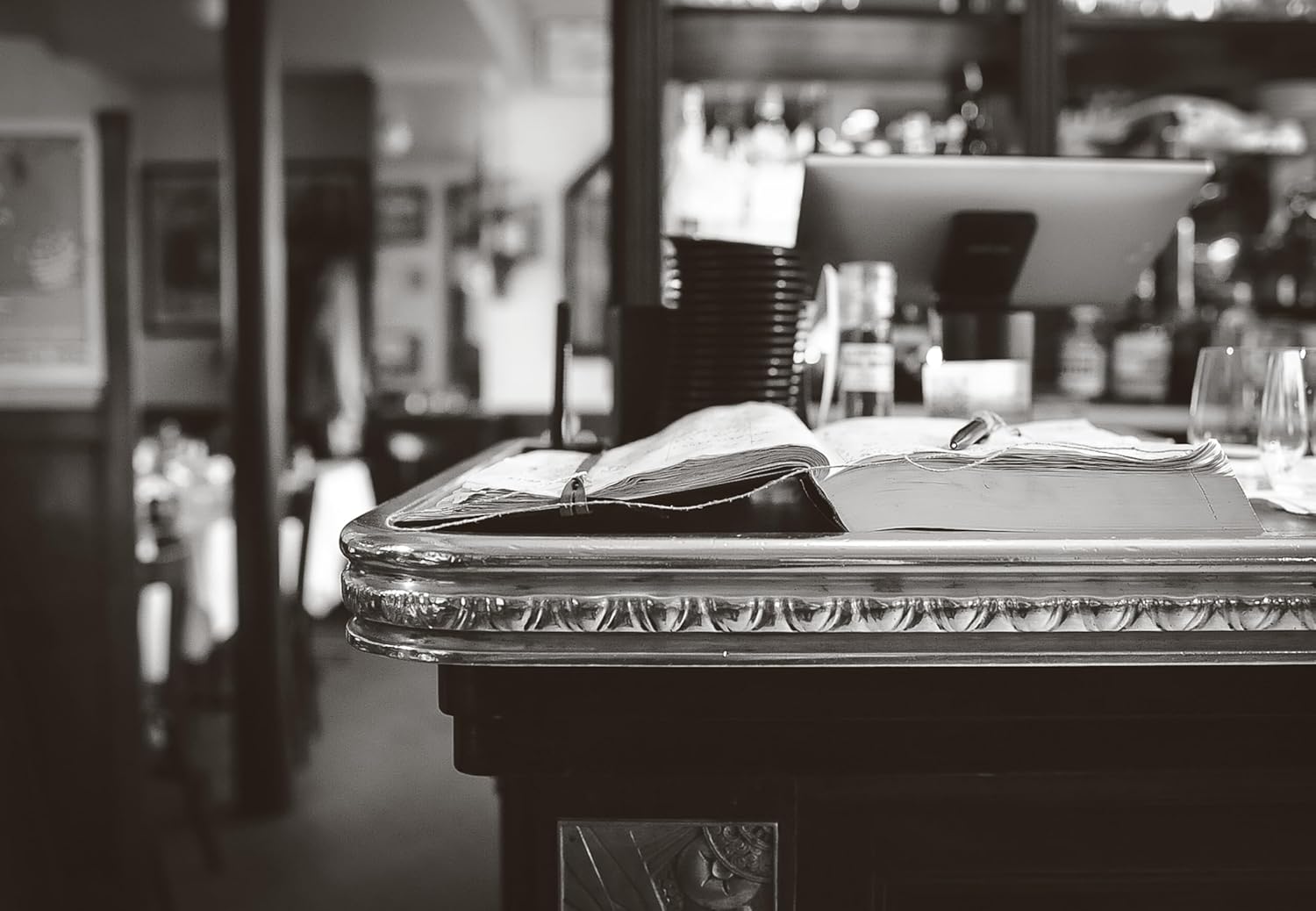 Bar counter with a menu and glasses in a bar setting