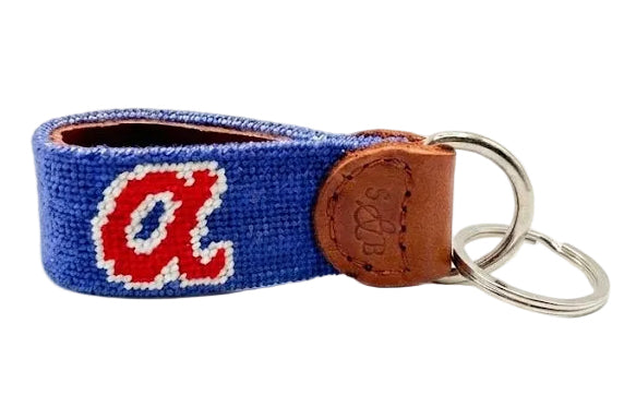 Keychain with a logo on a blue strap with a brown leather tag on a white background