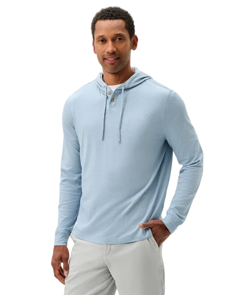 Man wearing a light blue long-sleeve hoodie on a white background