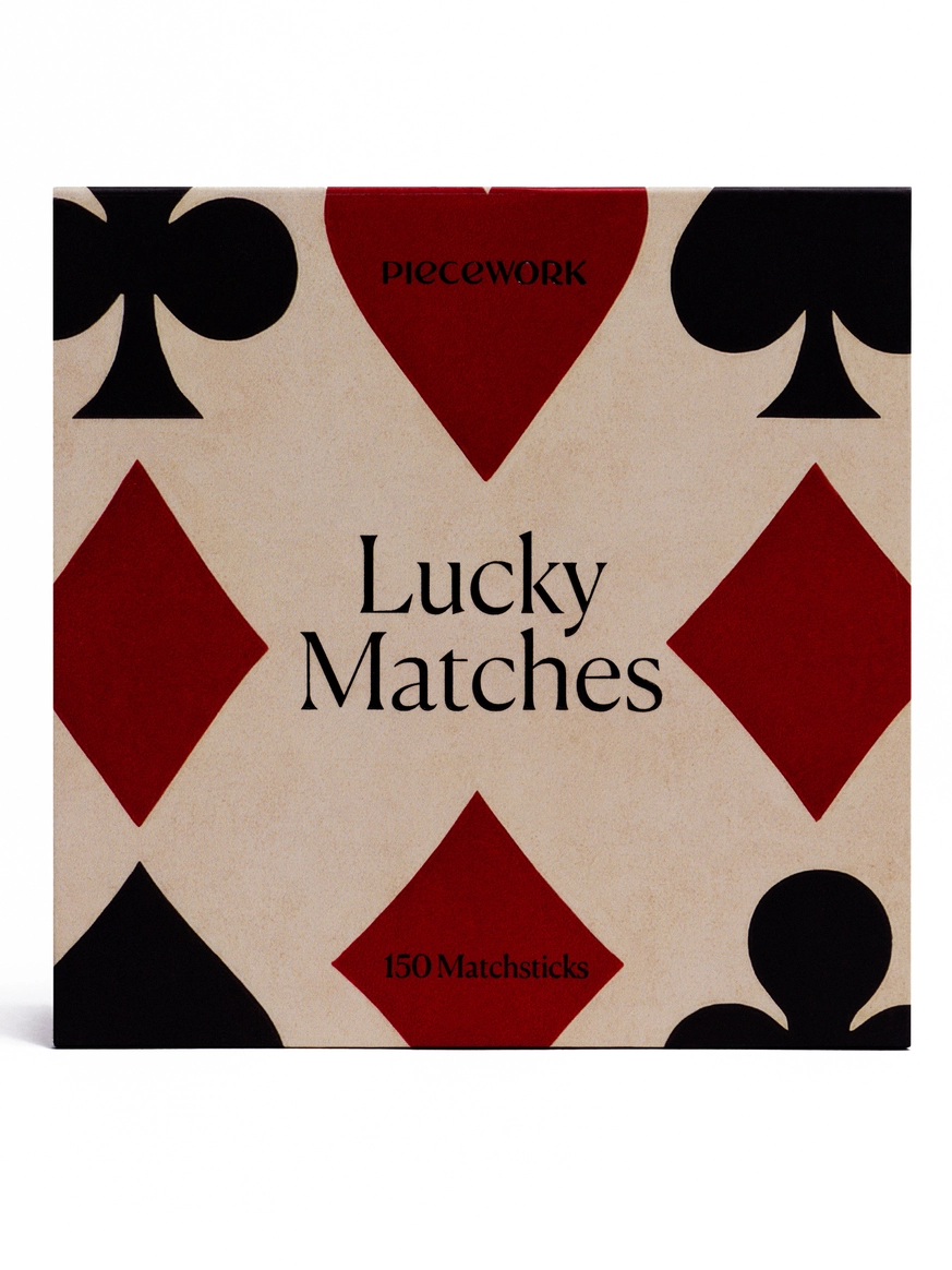 Matches packaging with playing card suit symbols on a beige background
