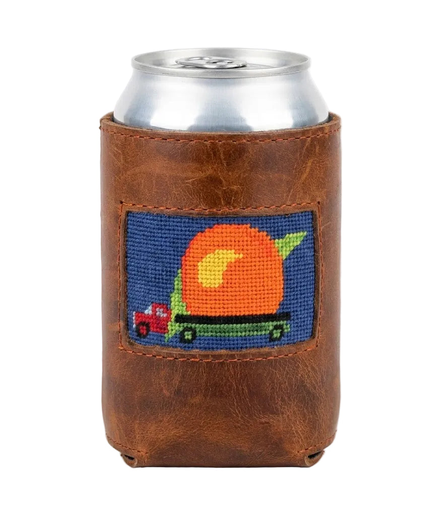 Brown leather can holder with needlepoint design featuring a pumpkin and truck on a white background