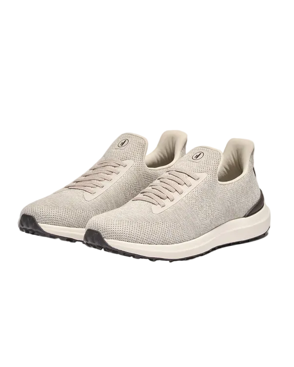 Pair of beige sneakers on a light gray background
