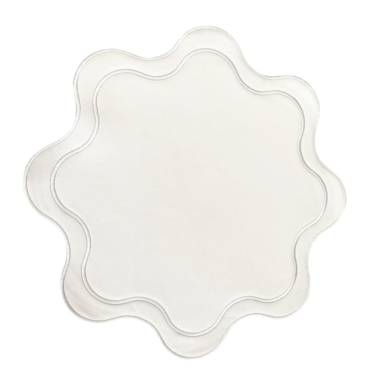 Decorative white plate with scalloped edge on a white background