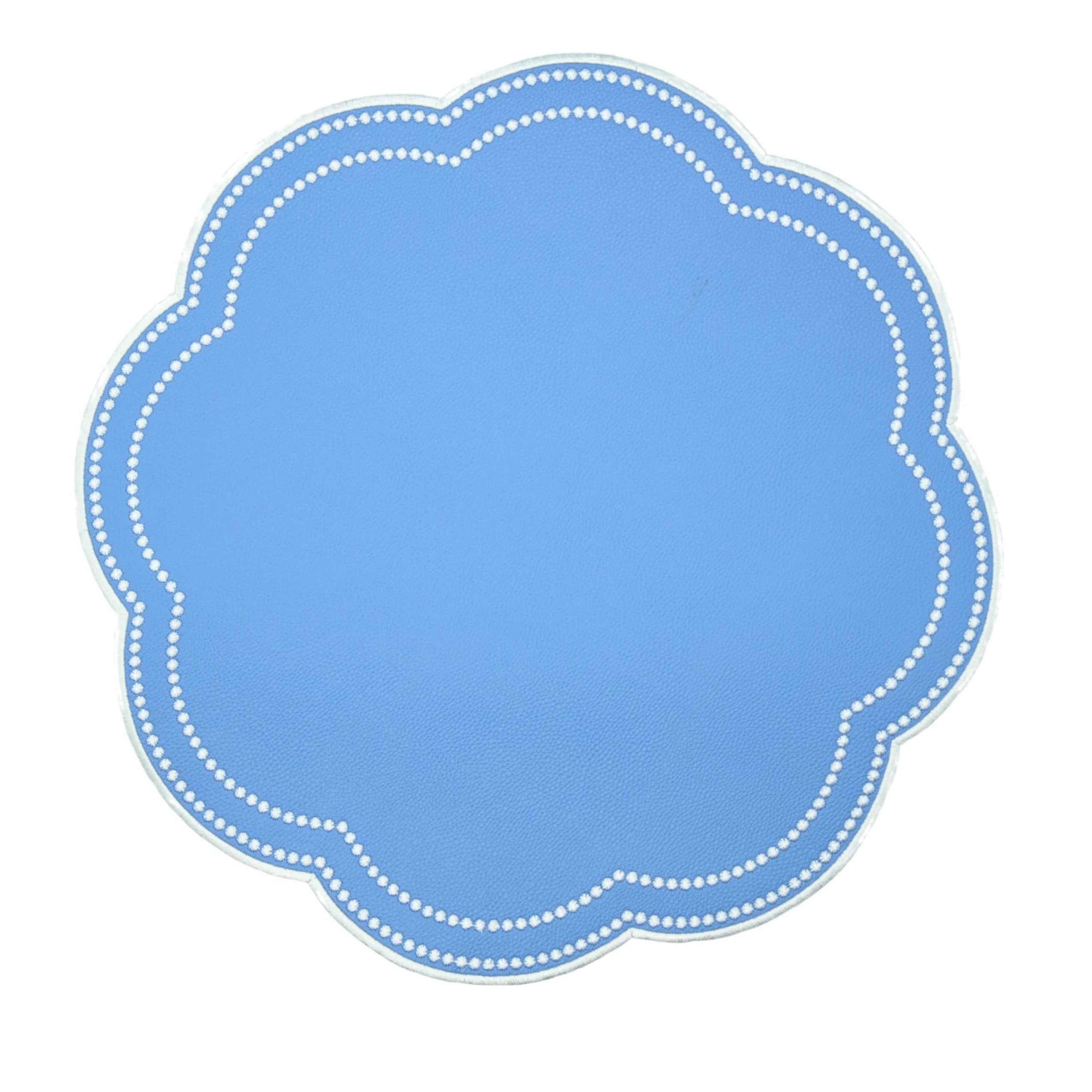 Blue placemat with white scalloped edge on a white background