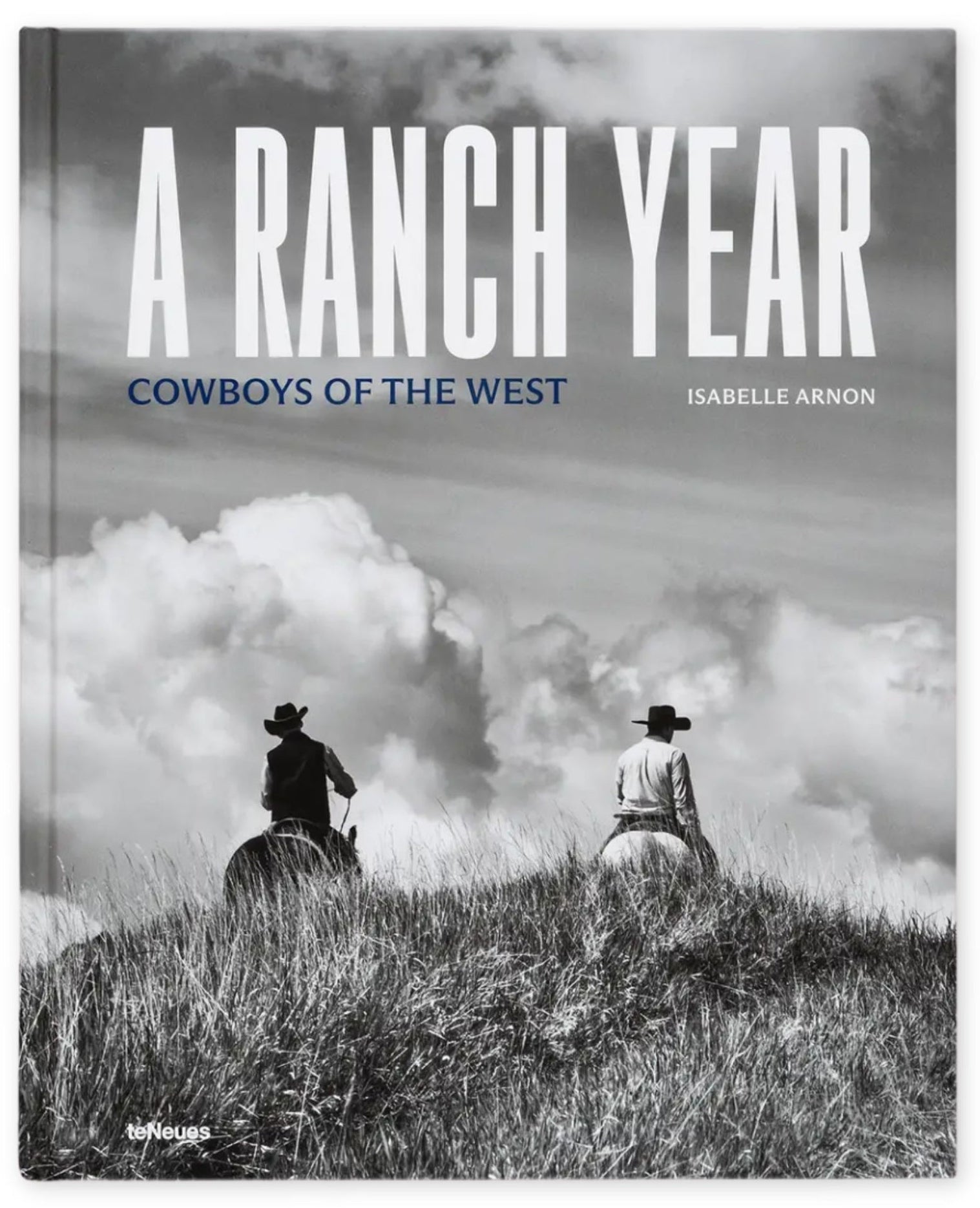 Book cover of 'A Ranch Year: Cowboys of the West' with two cowboys on horseback against a cloudy sky.