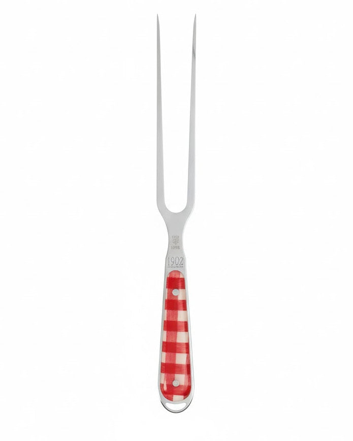 Carving fork with red and white checkered handle on a white background