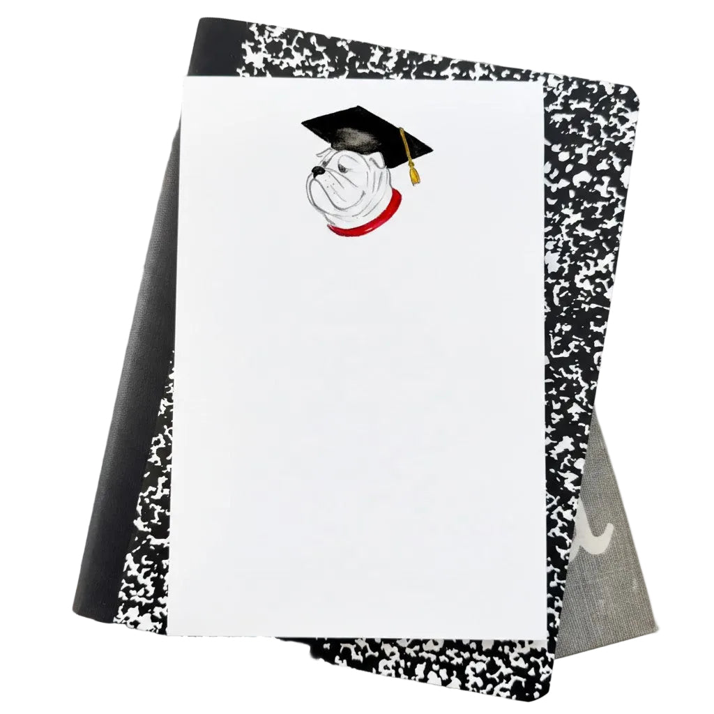 Notebook with a graduation design on a stack of books