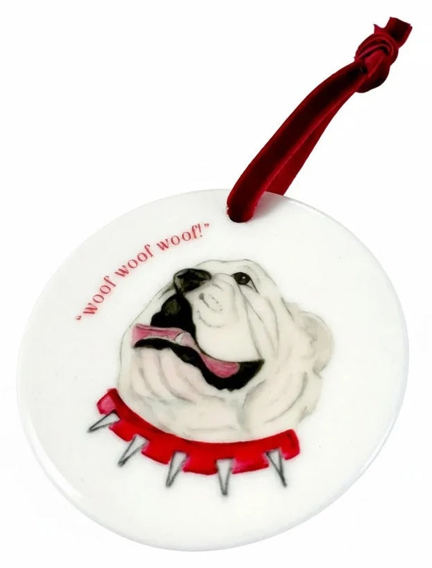 Decorative dog ornament with a red ribbon on a white background