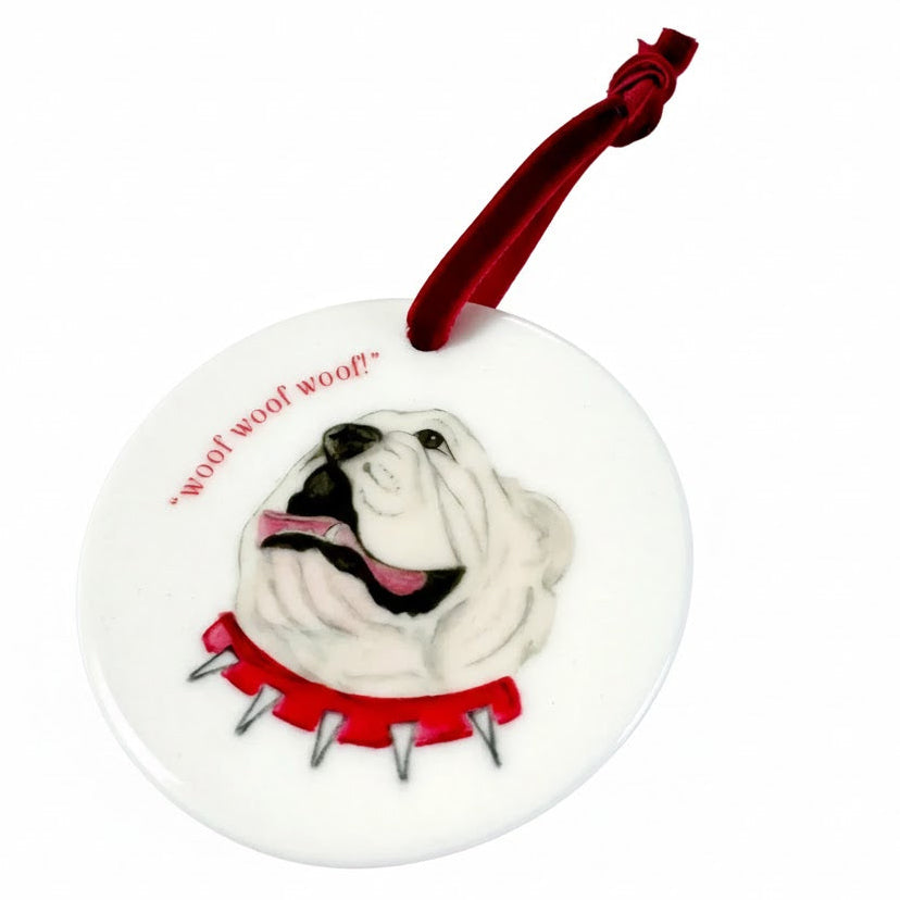 Decorative dog ornament with a red ribbon on a white background