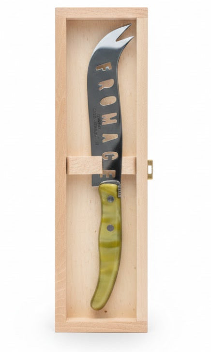 Knife with a green handle in a wooden box on a white background