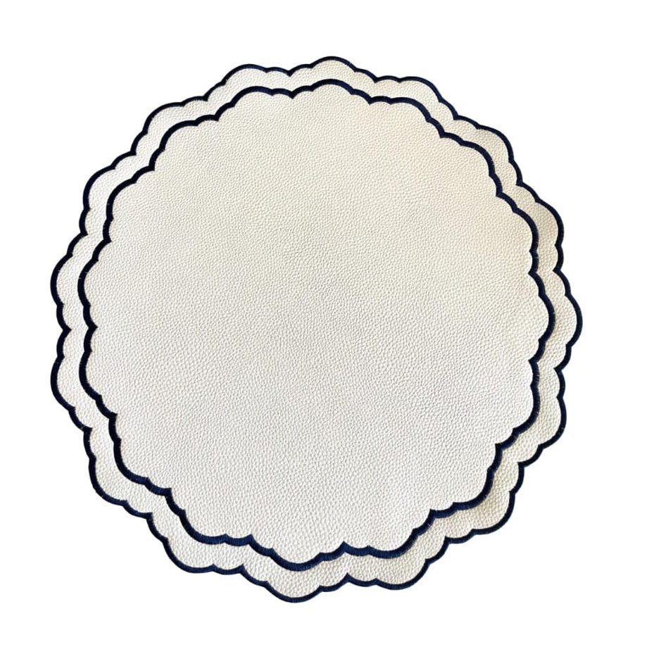Round white placemat with scalloped edge on a white background